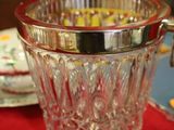 a glass ice bucket sitting on a red table