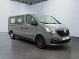 the grey van is parked in a large room with a black floor
