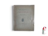 an old book on a white surface with a red and black logo