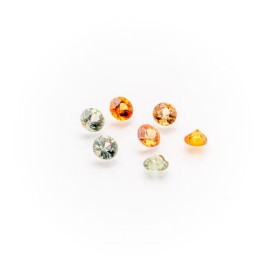 a group of five different colored gems on a white surface
