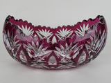 a close up of a pink glass bowl on a white surface