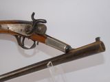 an old gun with a wooden barrel and a metal handle