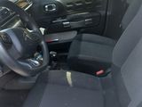 the interior of a car with a steering wheel and a dashboard