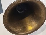 a brown vase sitting on a white table with a black base