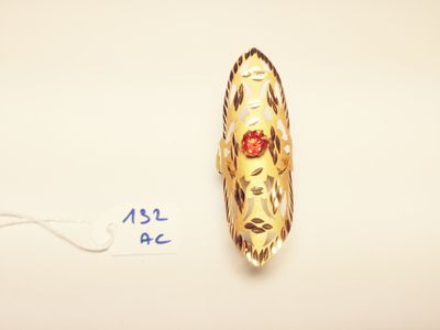 an image of a gold ring with a red stone in the center