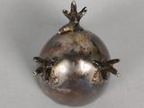silver plated pomegranate with two birds on top of it