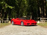 a red sports car parked on the side of the road
