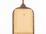 an old wooden frame with a cross hanging on a wall