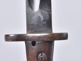 a close up of a knife on a wooden stand