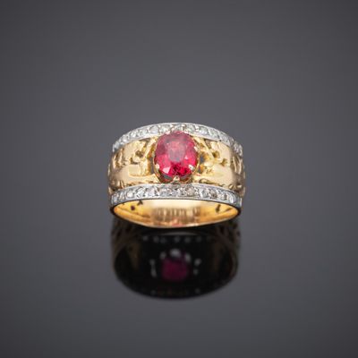a gold ring with a ruby stone and diamonds