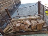 a cage with a bunch of wood inside of it