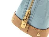 a close up of a blue purse with a gold zipper