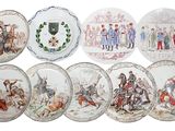 six plates with different designs of people on them on a white surface
