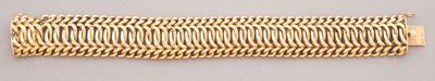 a close up of a gold bracelet on a white surface