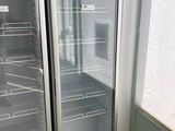 two refrigerators that are open in a kitchen