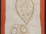 painting of a leaf and a flower on a wall in a wooden frame