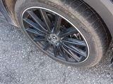 a close up of a car tire on the road