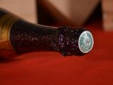 a bottle of wine sitting on a red table