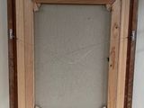 an old picture frame is sitting on a shelf next to a white wall