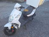a scooter with a box on the back of it
