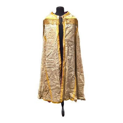 gold and black cape on a mannequin stand on a white background
