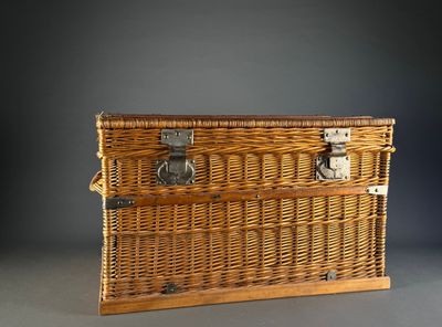a wicker trunk with a metal latch on it