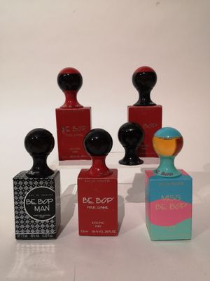trois petits flacons de parfum posés l'un à côté de l'autre sur une table