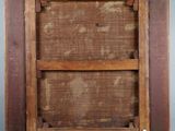 an old wooden picture frame hanging on a blue wall