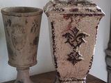 two vases sitting on a table next to each other