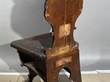 a wooden chair that is sitting on a tile floor