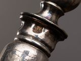 a close up of a silver object on a black background