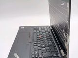 a black laptop with a red button on the keyboard