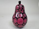 a black and pink vase sitting on a white surface