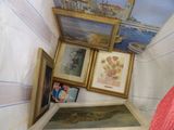 a bed with a red comforter and pictures on the wall