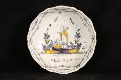 a white bowl with a picture of a woman and a bird on it