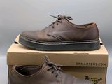 dr martens shoes in a box on a white surface