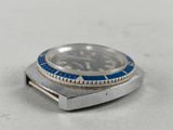 a close up of a watch on a table with a white background