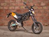 a motorcycle that is parked in front of a brick wall