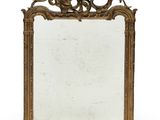 an ornately carved mirror is shown against a white background