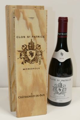 a bottle of wine sitting next to a wooden box