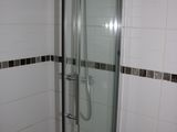 a shower with a glass door in a bathroom