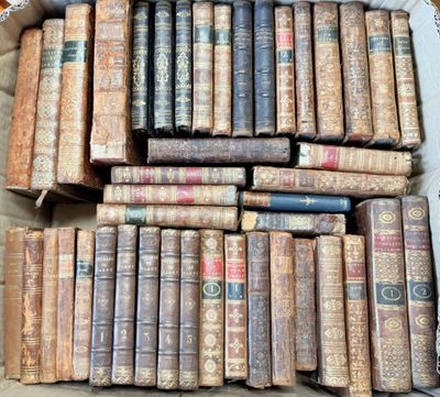 a lot of old books in a box on the floor