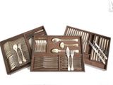 a set of silverware in a wooden box on a white background