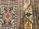 a close up of a rug on a wooden floor