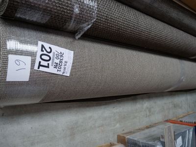 many rolls of fabric on a shelf in a store
