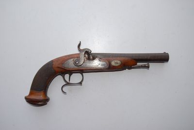 an old gun with a wooden handle on a white surface