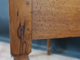 a close up of a bed with a wooden headboard
