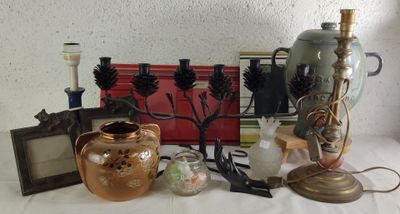 une table sur laquelle se trouvent une lampe, un vase, un cadre photo, un cadre photo et un cadre photo