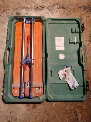 a green case with tools inside of it on the ground