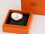 an orange box with a white bowl inside of it on a white surface